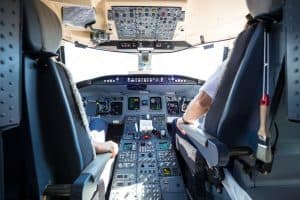 image of cockpit with pilot with knee pain